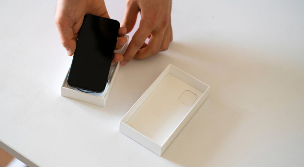 a person holds the new smartphone box