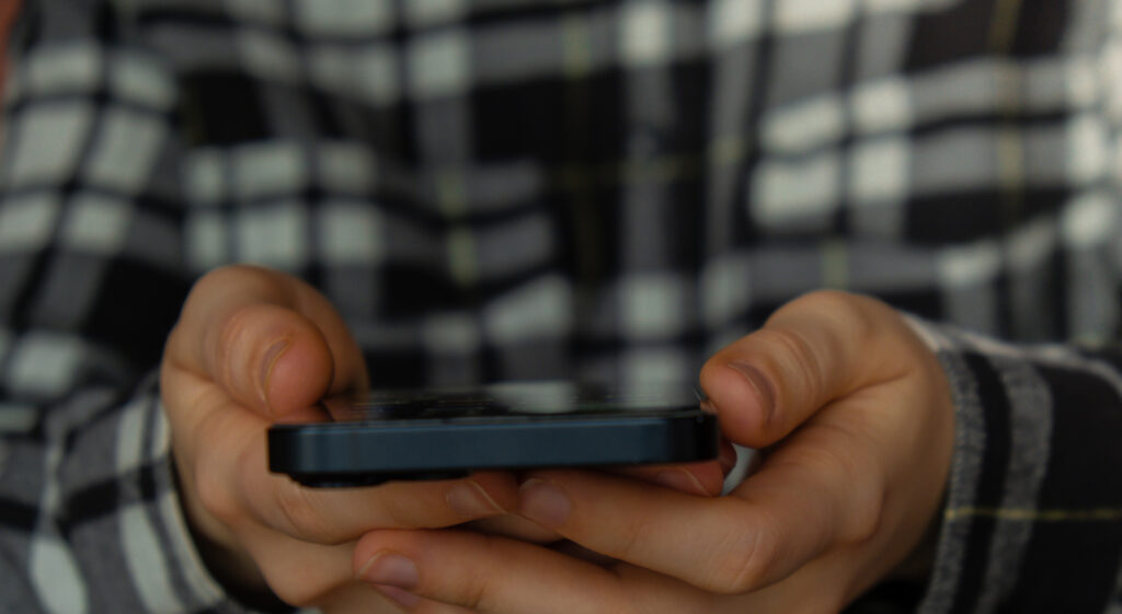 close up shot of woman s hands tapping on mobile