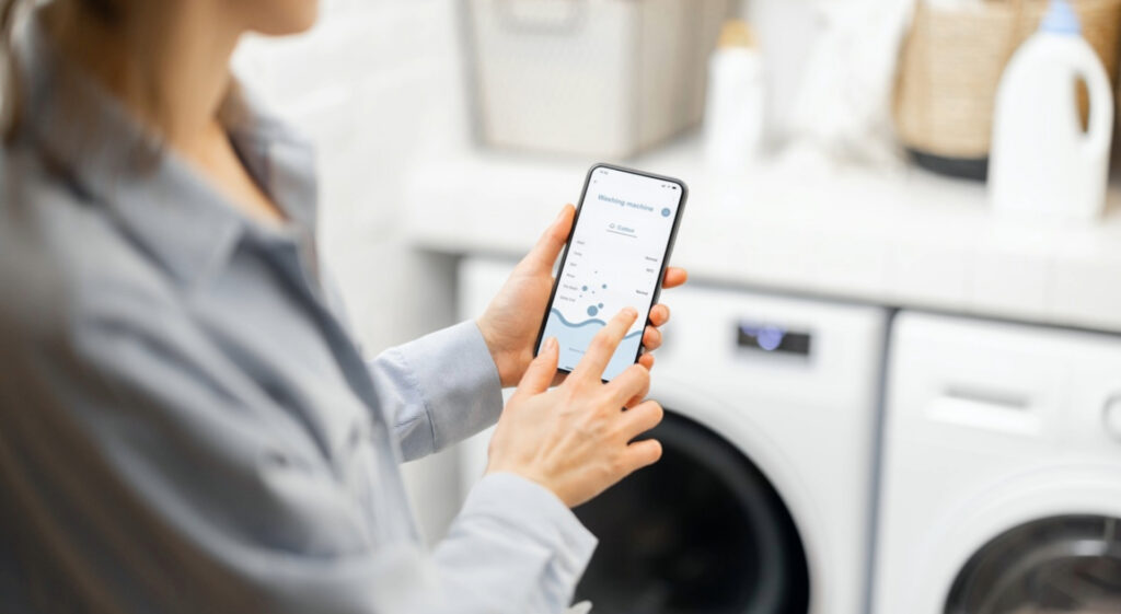 woman using smartphone for smart washing machine c 2026 03 25 00 54 23 utc Large