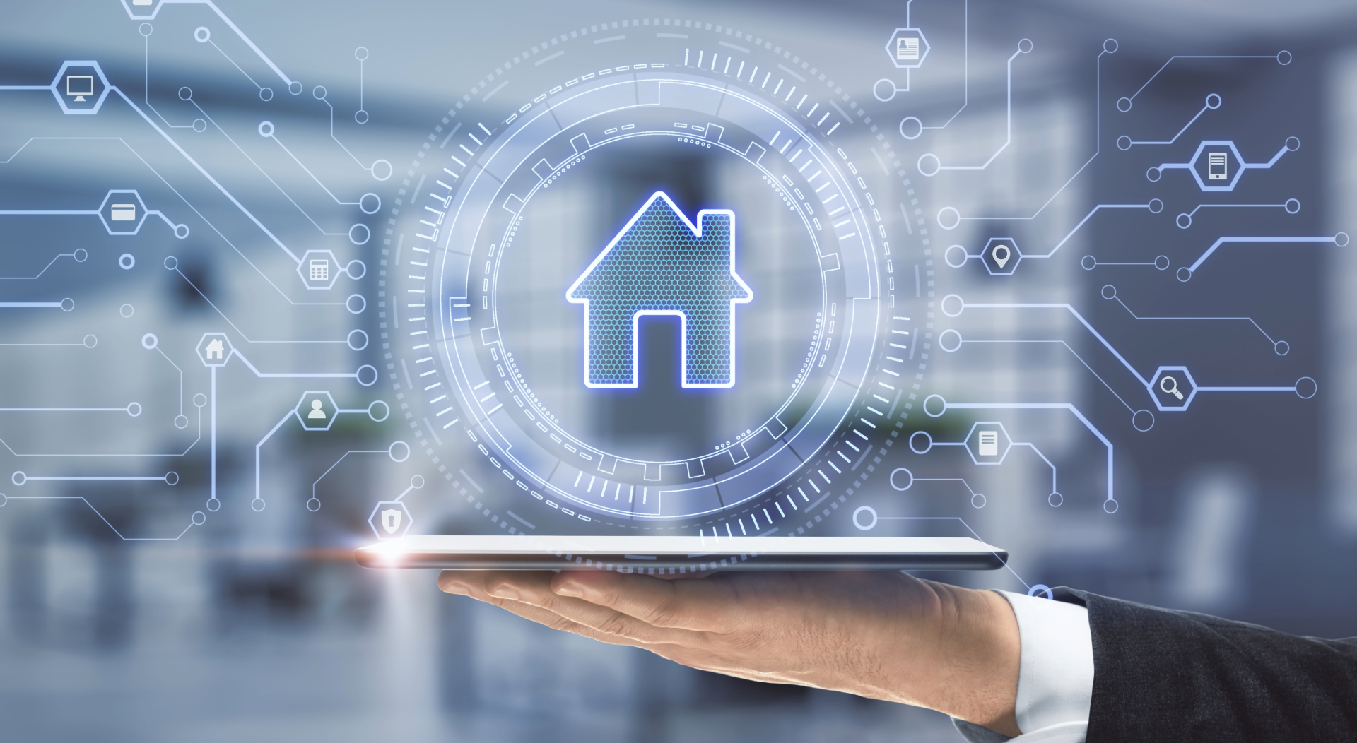 Hand holding tablet displaying smart home technology
